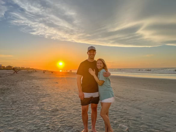 Folly Beach sunrise engagement photo of a couple, to show how useful a compact portable tripod can be for people who long-term travel