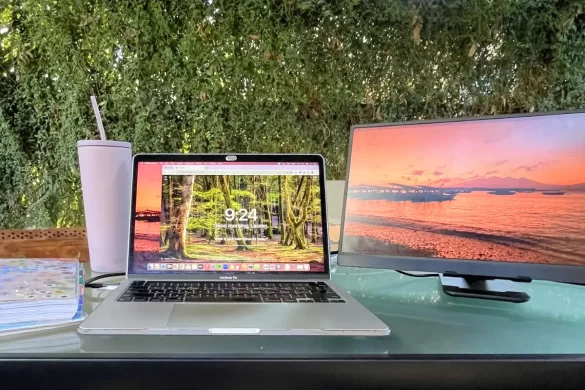 Portable monitor setup showing it as important digital nomad gear, alongside a connected laptop and reusable water bottle