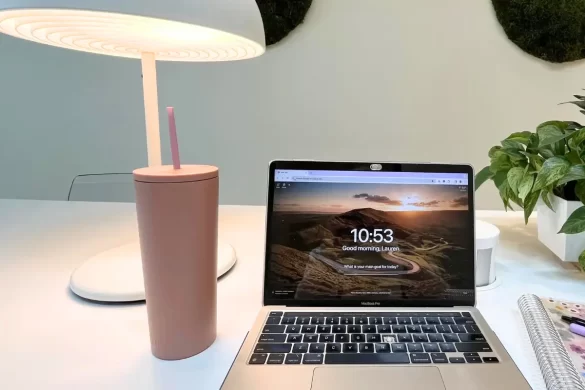 Reusable water bottle shown next to a Macbook Pro, because these are the two most important things for digital nomads to have with them as they travel