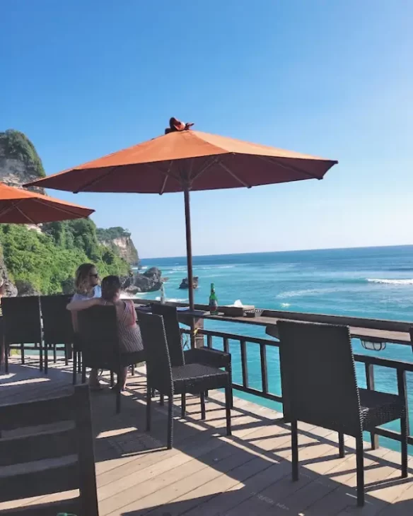 Tables and chairs overlooking Suluban Beach at the Delpi Cafe