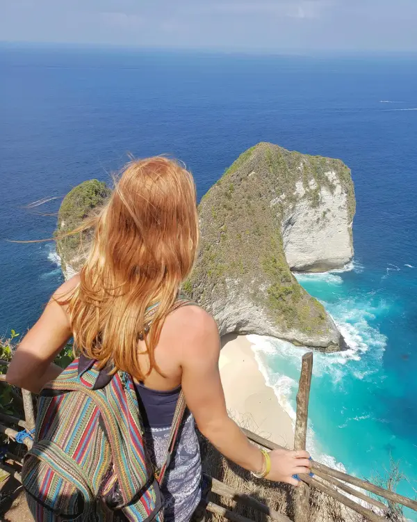 Photo of a solo traveler looking out over KelingKing Beach, to demonstrate independence