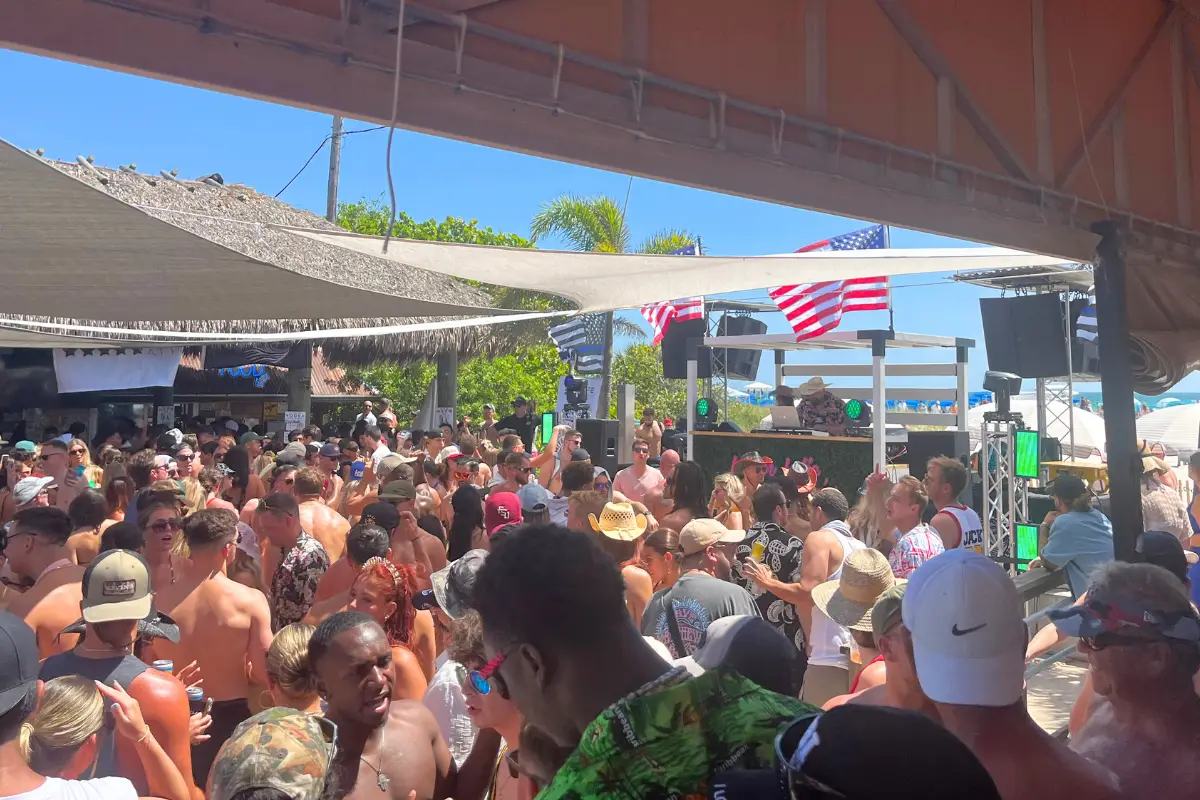 The PCI Beach Bar at the Postcard Inn in St Pete Beach, with a large crowd in front of the DJ booth 