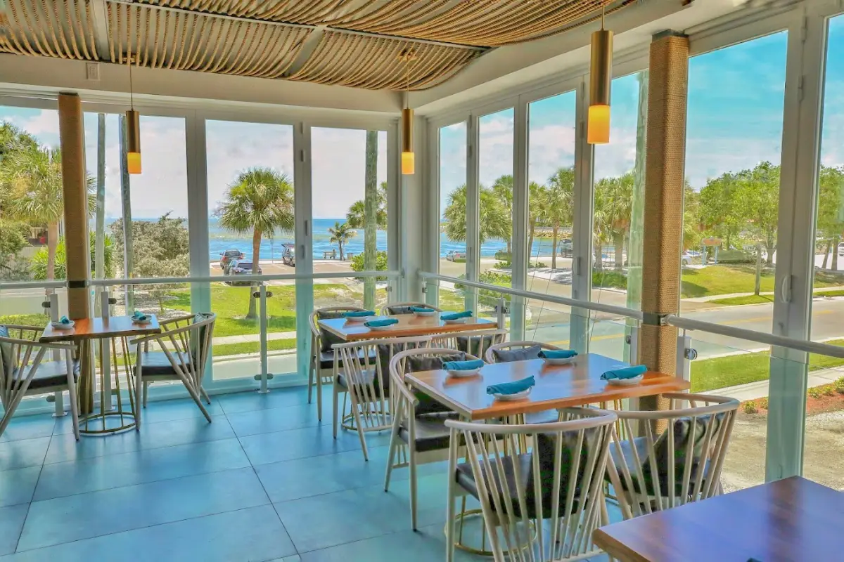 The interior dining room with floor to ceiling windows at 82 Degrees, which is a brunch restaurant in St Pete Beach