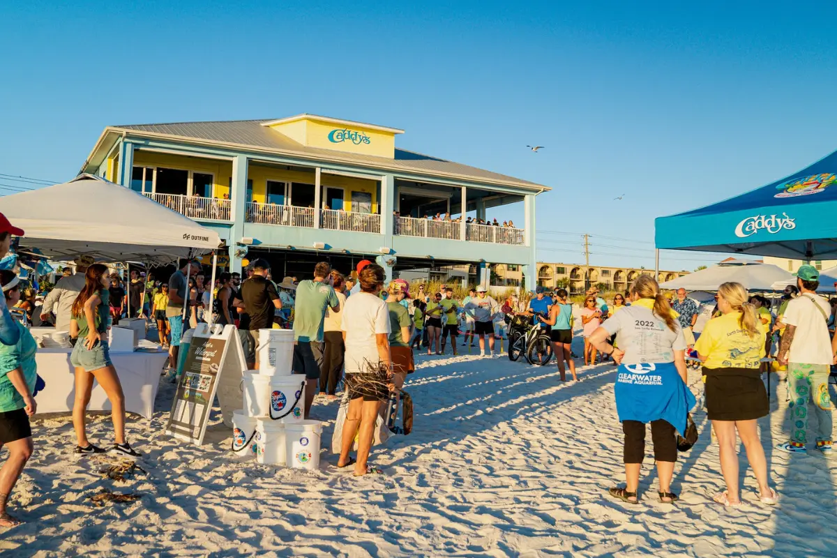 Exterior of Caddy's Madeira Beach during the late evening with people standing around hanging out 