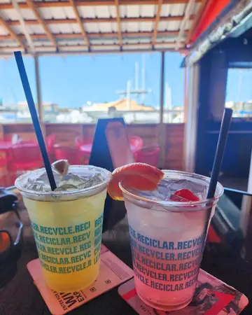 Two mixed drinks on the outdoor patio at Hippe Shack, which is on the water in Treasure Island FL