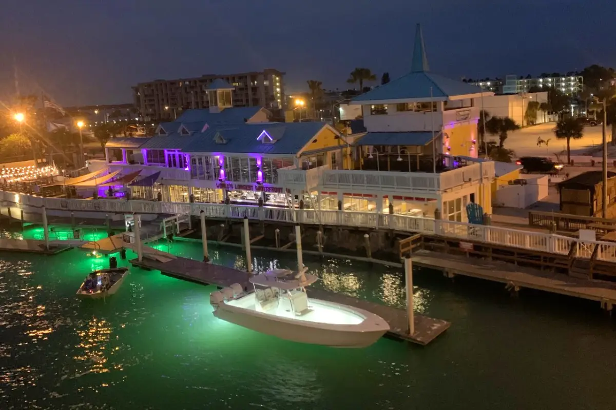 Crabby's on the Pass at night from an aerial view, with lights illuminating the area