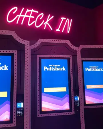 Digital check in machines at Puttshack