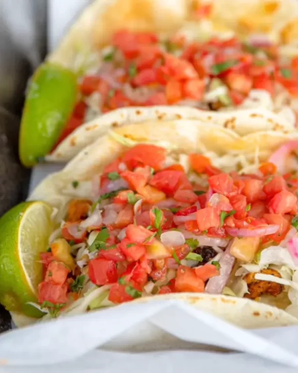 An up close shot of tacos with tomato salsa on top at Taco Shop Treasure Island