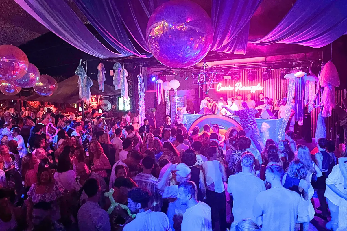 Cova Santa Ibiza club with a crowded dance floor and giant disco ball at the Cosmic Pineapple party