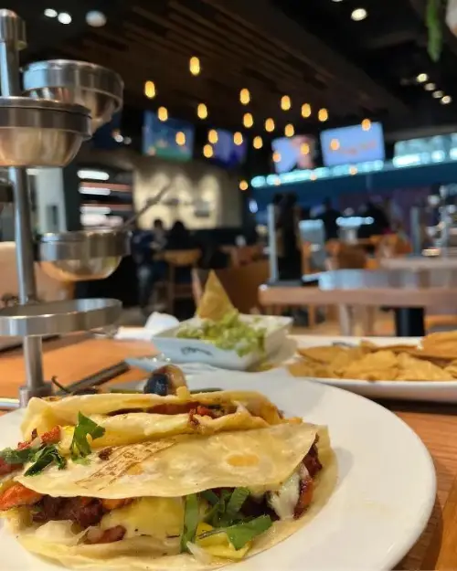 Gringas and appetizers on a table at El Fogoncito at NLU Airport, showing that they have delicious food options