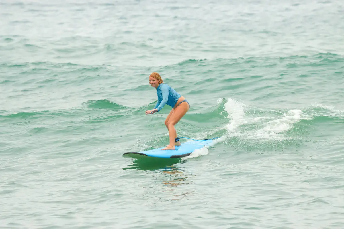 Woman riding a wave with a smile