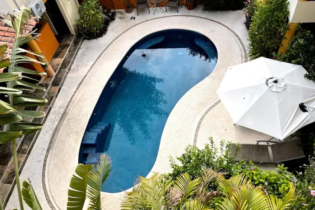 Pool at La Barca surf house and view from room