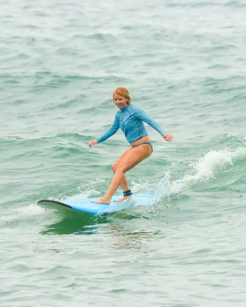 Lauren Edmondson of Inspired Backpacker riding a wave