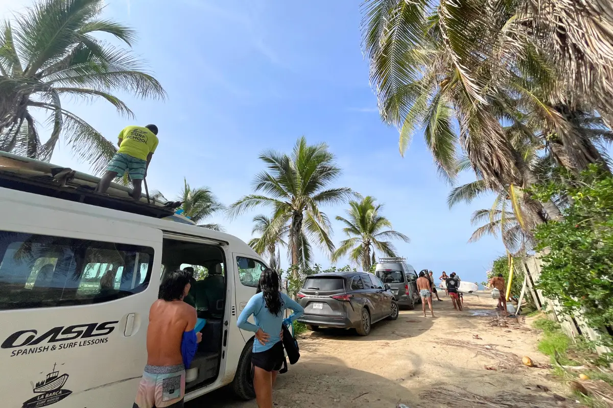 Oasis Surf Camp instructors and students unloading the van getting ready for surf lessons 