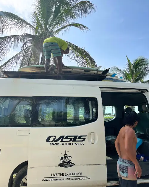 Oasis Surf School's van with the instructors unloading 