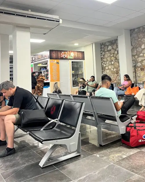 Puerto Escondido airport departures waiting room with people sitting