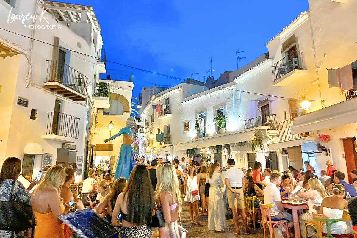 A main street in the Ibiza Town in Dalt Vila, with performers and spectators, and lots of energy