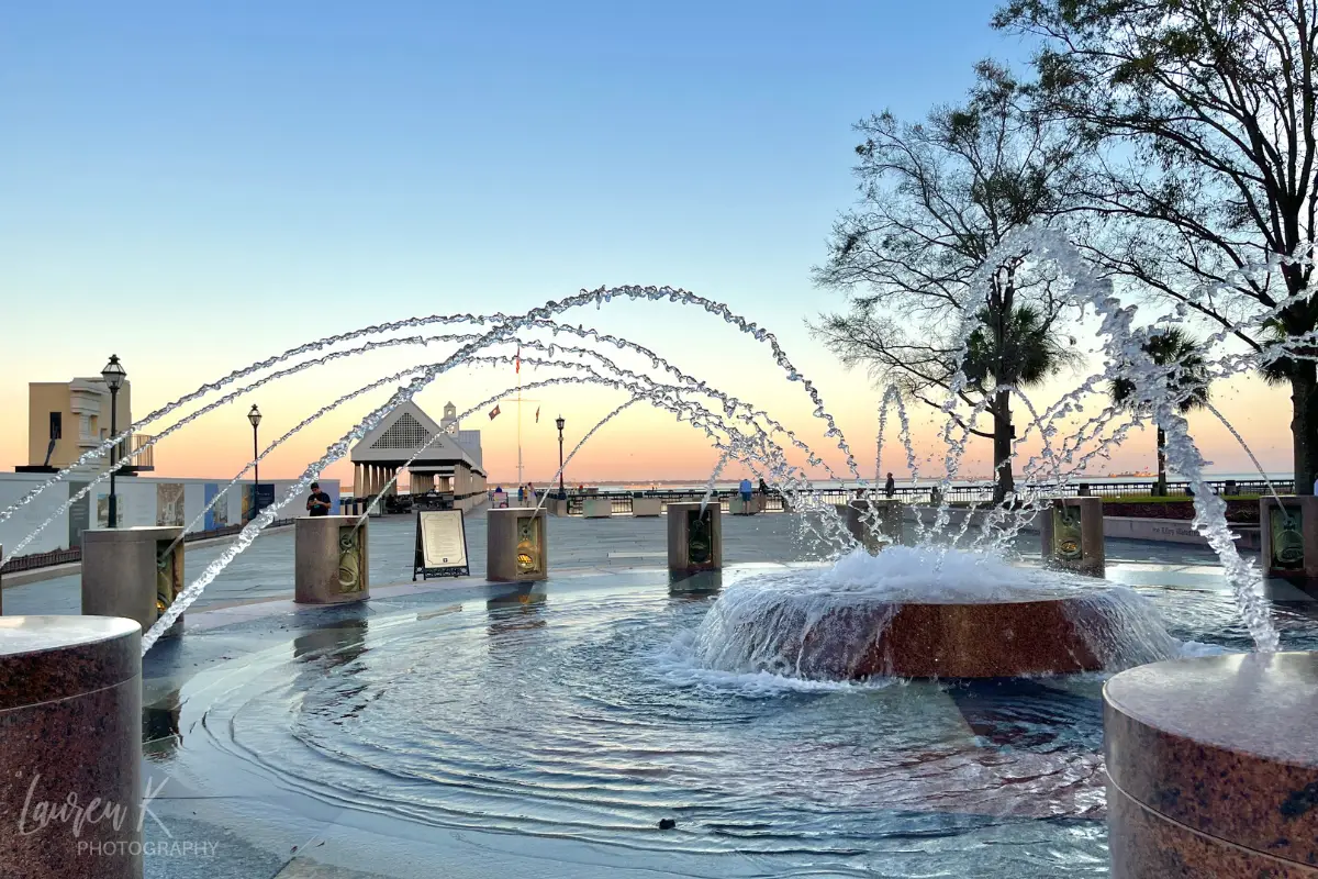 Fountain on the Charleston harbor during sunset, to demonstrate that the harbor is a great choice for where to stay in Charleston SC. Photo taken by Lauren Kessel photography