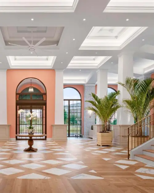 The high ceilings of the interior lobby at the Embassy Suites Mount Pleasant hotel, with arches and palm trees