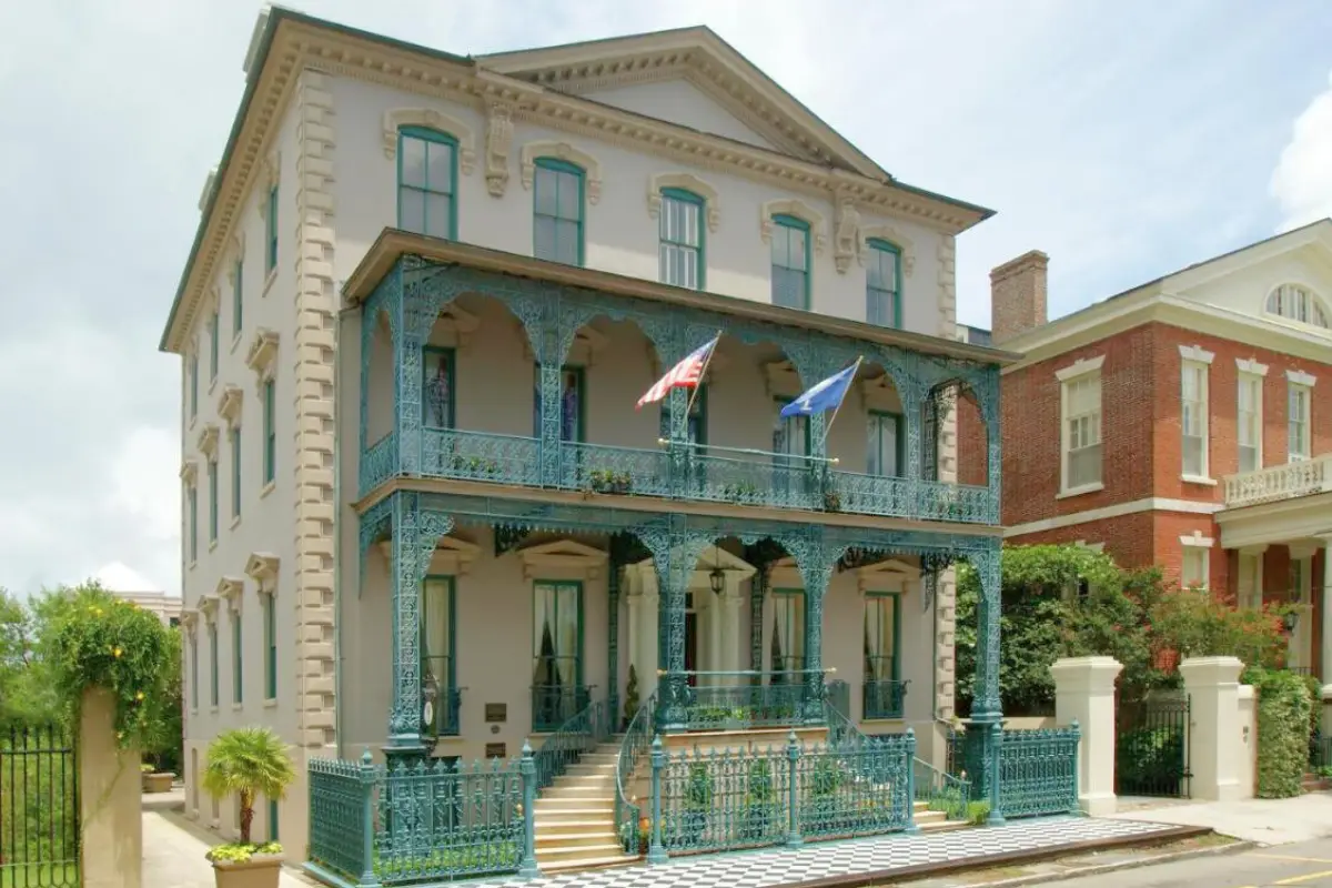 The beautiful French exterior of the John Rutledge House Inn with flags blowing in the wind