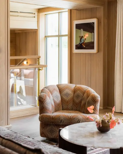 Lobby area of the Ryder Hotel with a trendy chair and textured walls