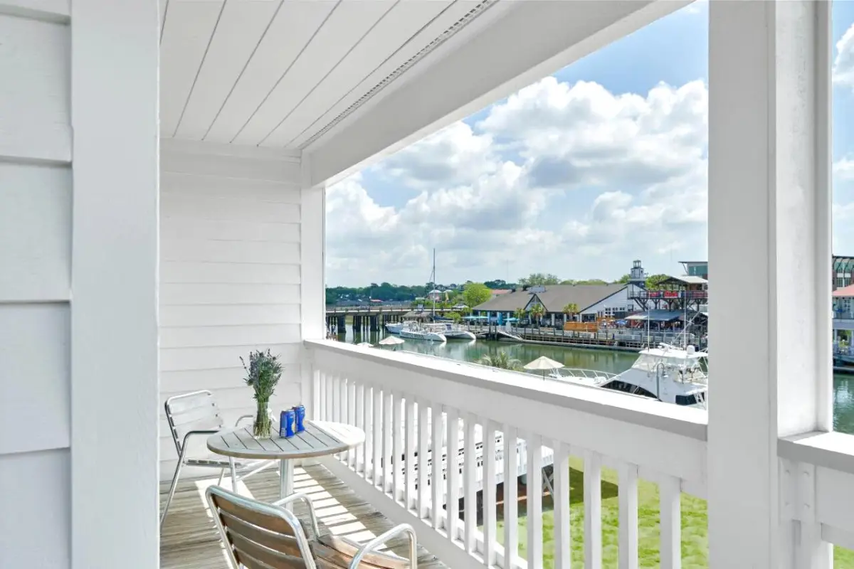 Balcony with a little table and a view of the Shem Creek 