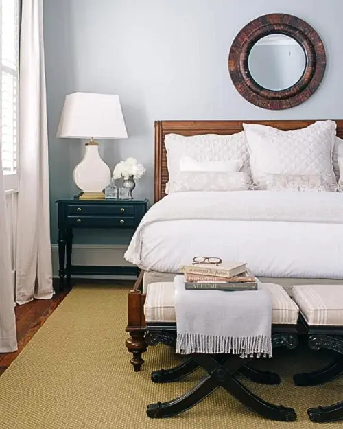 Nicely decorated shot of a bedroom and mirror at the Zero George hotel