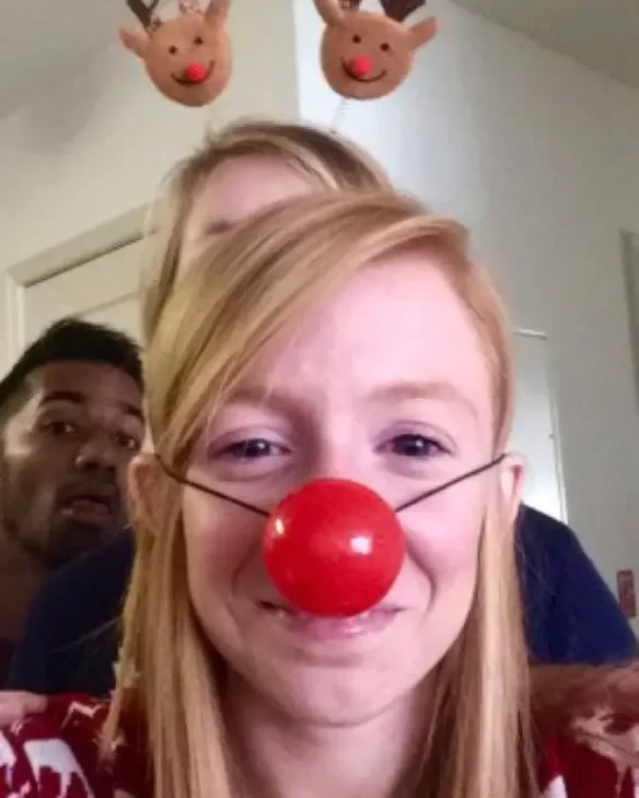 A girl with a costume reindeer nose 