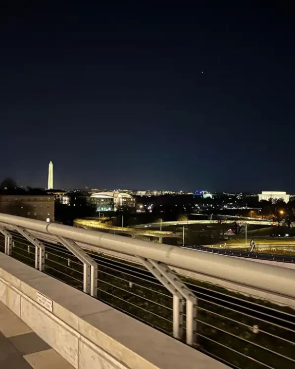 The National Monument and aerial view of DC from the rooftop of the Kennedy Center lit up at night