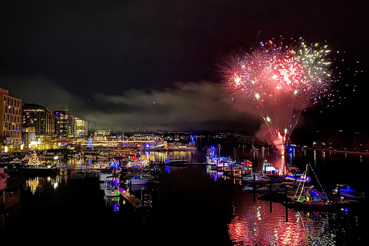 Fireworks going off over the Potomac at the Wharf's Holiday boat parade