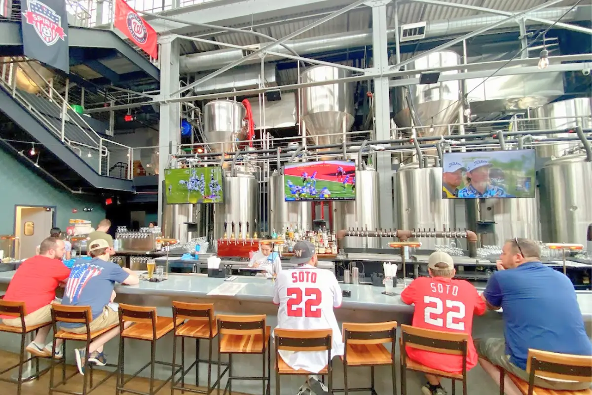 Washington DC sports fans sitting at the bar at Bluejacket with sports on the TVs in the background