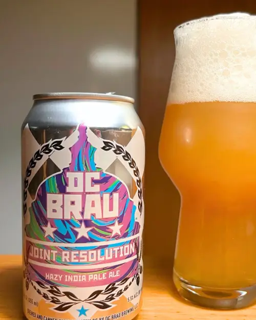 The DC Brau's Joint Resolution beer in a can with it poured into a pint glass 