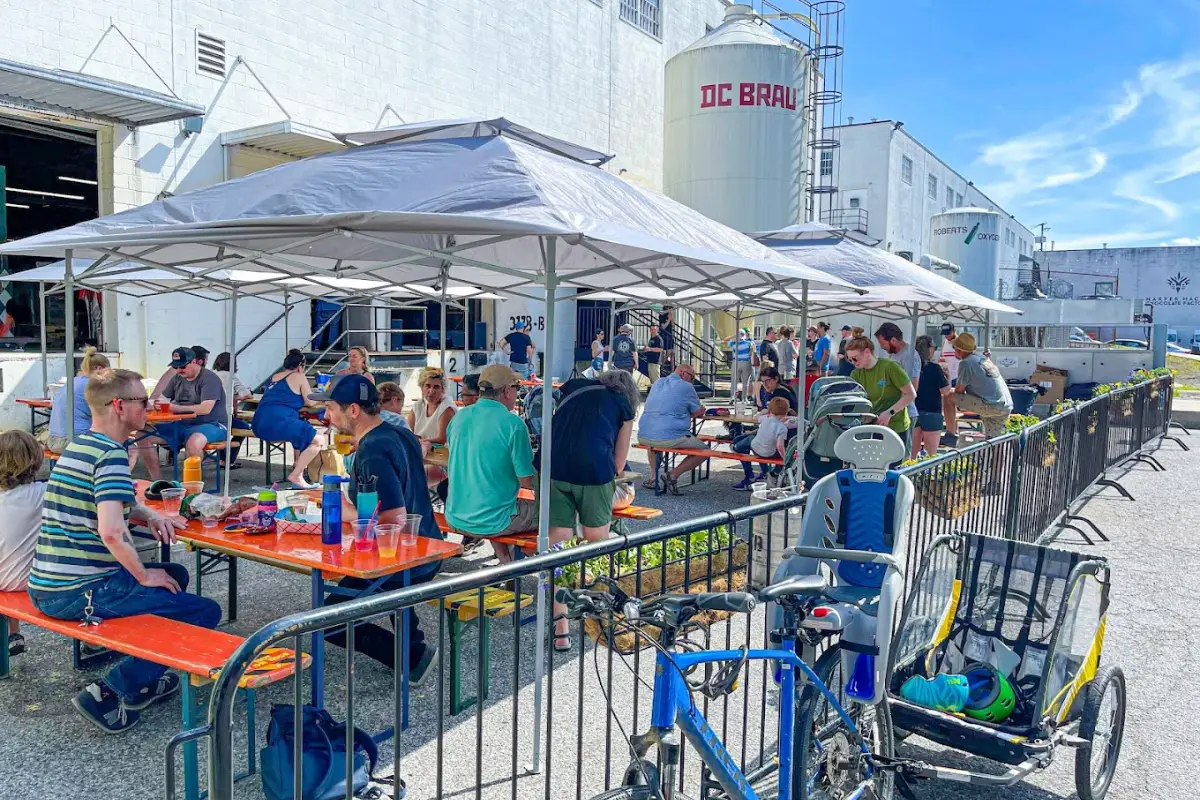 The outdoor space at DC Brau filled with people on a sunny day, showing that it's one of the best Washington DC breweries to visit on a nice weather day