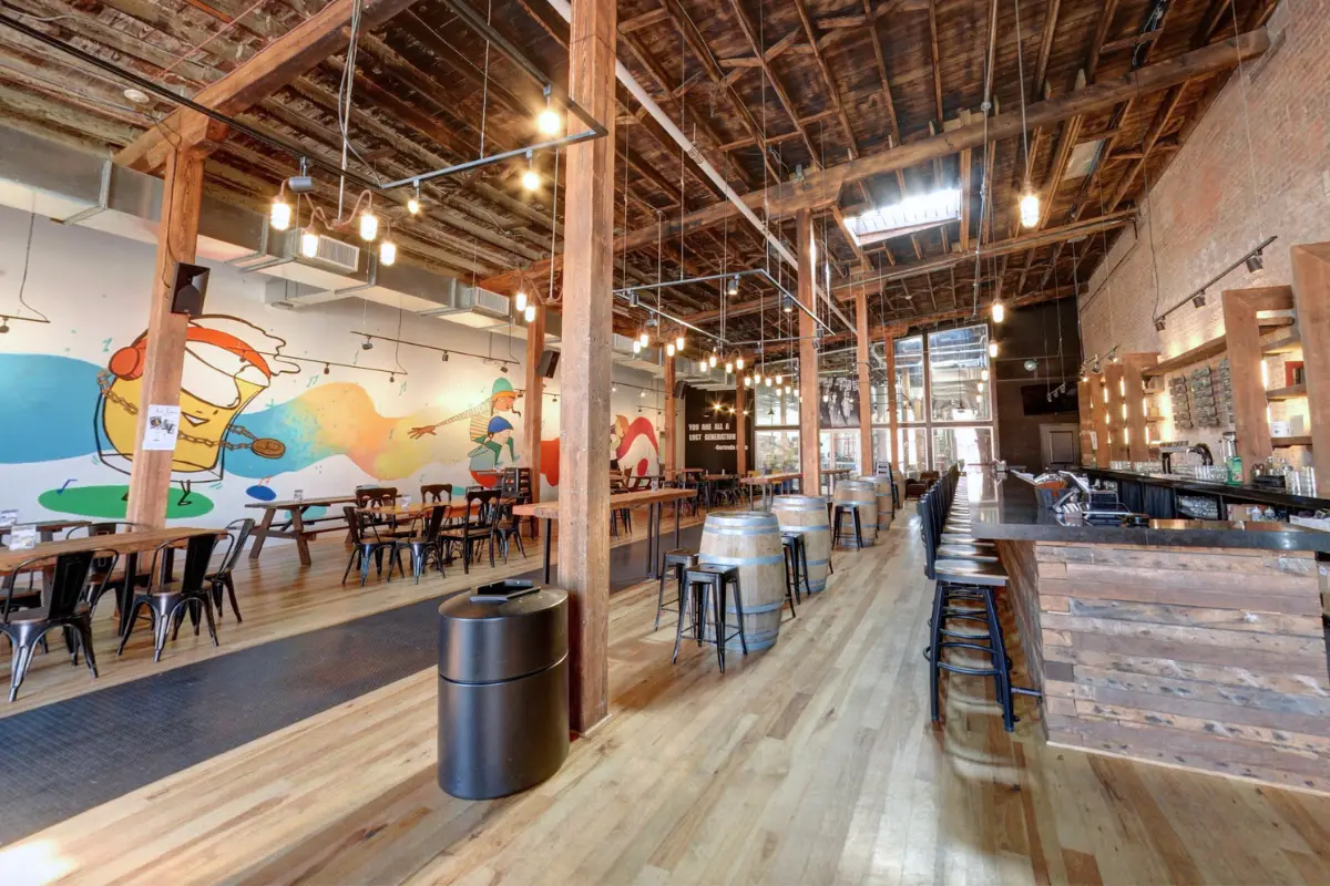 Indoor space at one of the best Washington DC breweries, Lost Generation, with lots of tables, a large bar and high vaulted ceilings