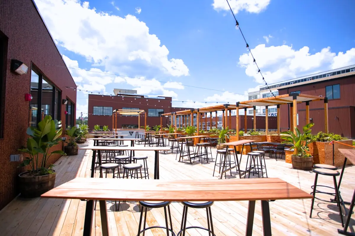 An empty outdoor patio with cabanas and tables at Other Half Brewing on a sunny day, making it one of the most Instagram-worthy Washington DC breweries 