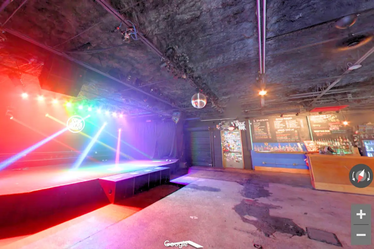 Screenshot of the virtual tour of the venue, with rainbow lights shining from the main stage