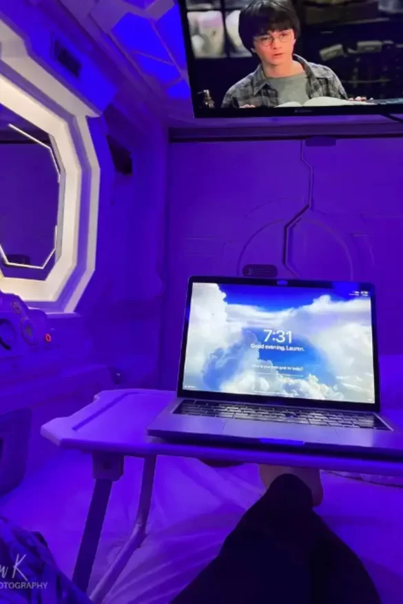 POV view of my laptop on my lap in one of the pods at the IzZzleep capsule hotel terminal 1, which is the best budget Mexico City airport hotel