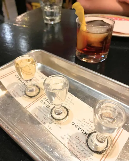 Sake flight in three little shot glasses 