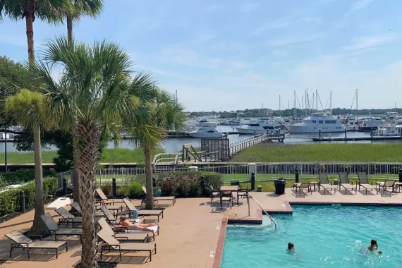 Courtyard Charleston Waterfront review cover image, showing the beautiful waterfront pool deck and palm trees