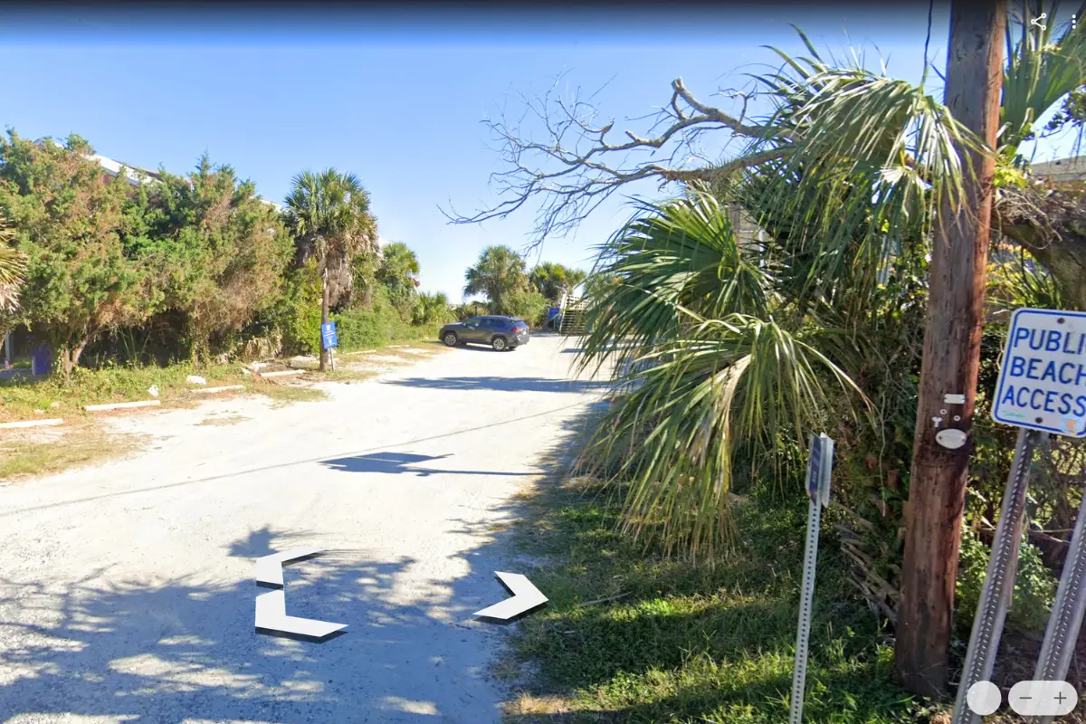 Screenshot of Google Earth which shows the 4th St W public Folly Beach parking lot during a sunny day with one car parked