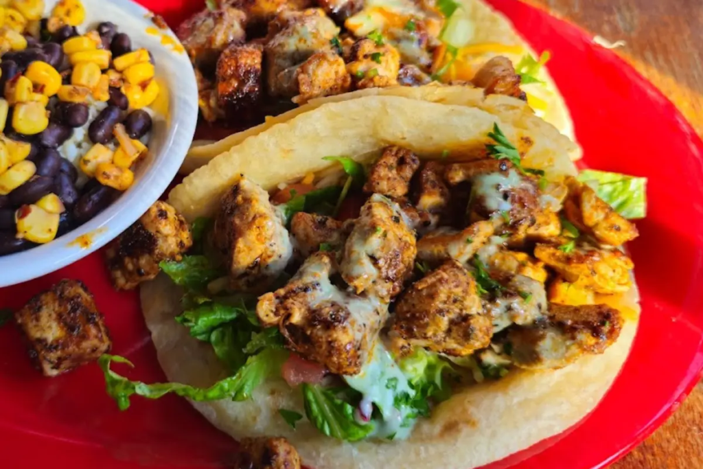 Cabo Fish Taco tacos with juicy meat on a red plate